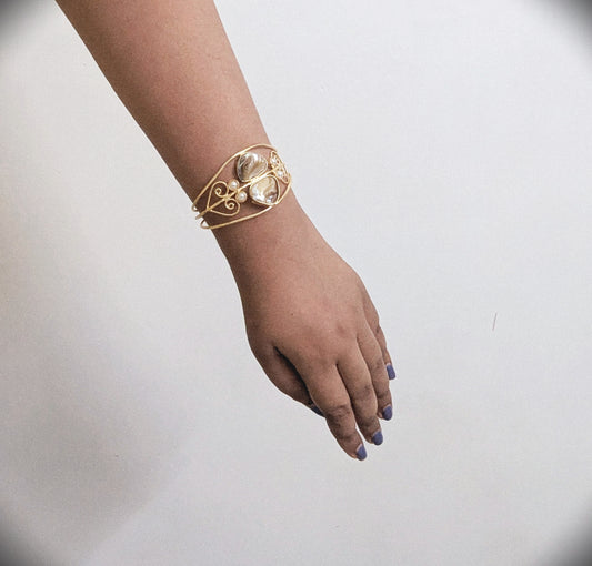 Gold bracelet on a wrist