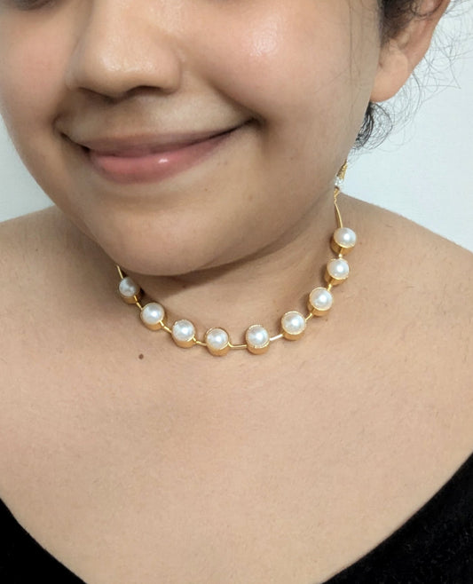 Person wearing a pearl necklace